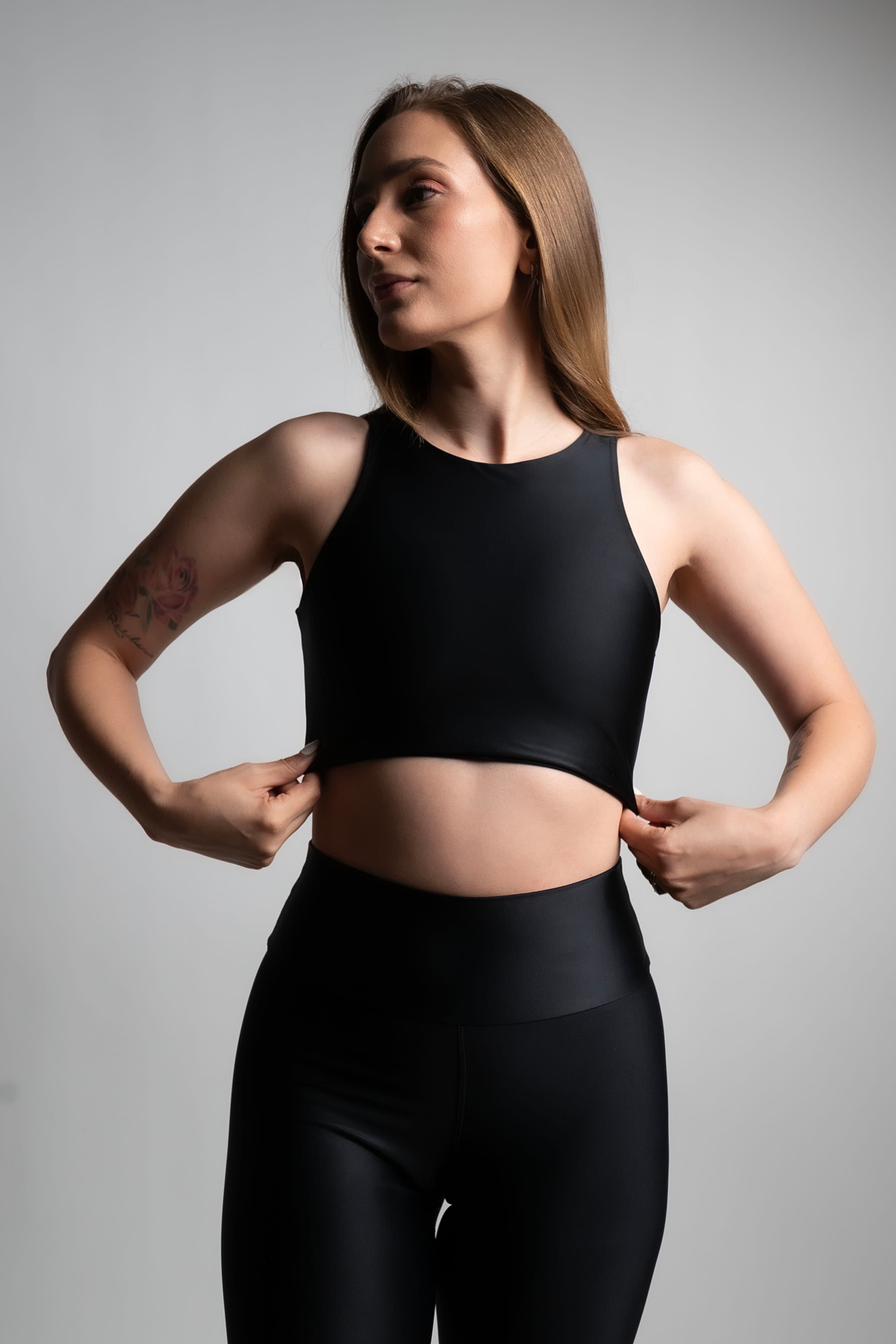Fotografía comercial de ropa deportiva, conjunto negro, medio cuerpo sobre fondo de estudio